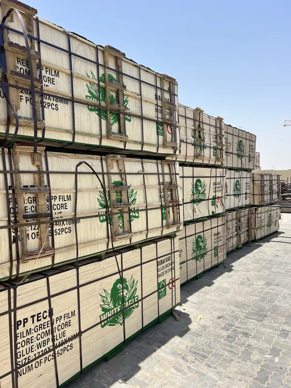 Rows of strapped plywood bundles stacked three high